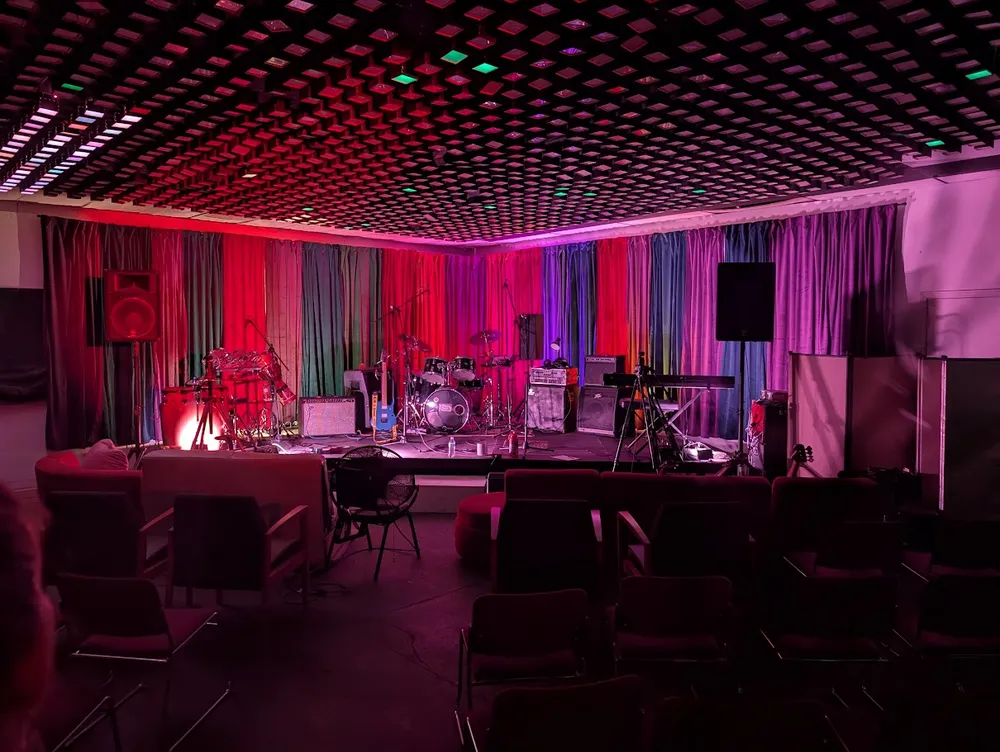 The Stage at Maker Radio — drums, amps, and colorful lighting